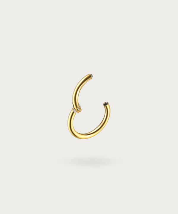 Close-up of the Paulina Forward Helix Hoop Piercing, gold clicker