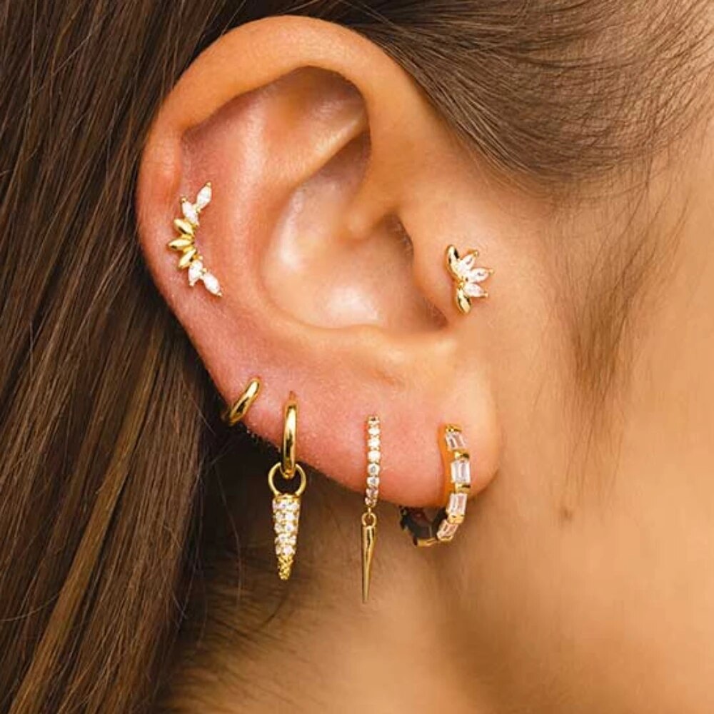 'Aria' ear jewelry with sparkling zircon, embodying discreet luxury and modern elegance worn on a female ear