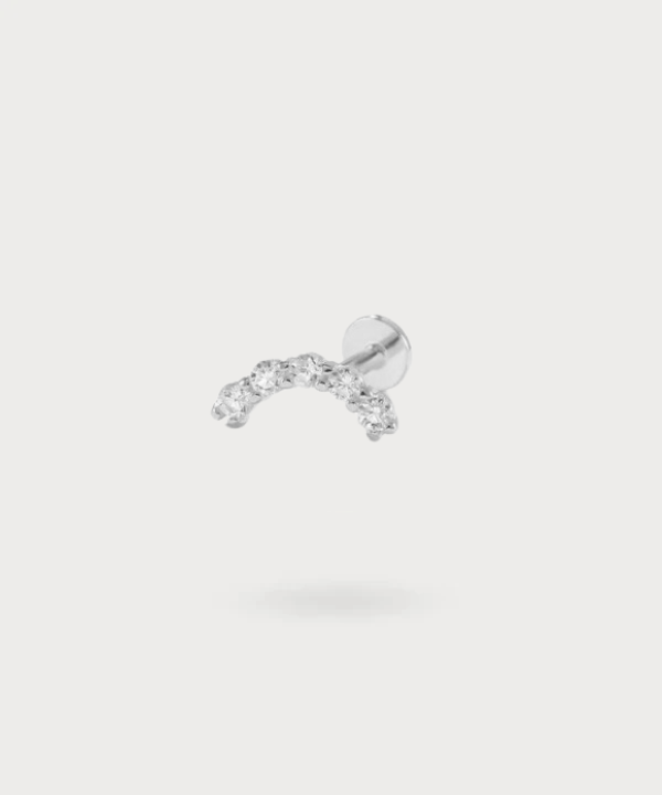 The Lourdes flat piercing worn, showcasing its perfect fit on the ear's flat area.