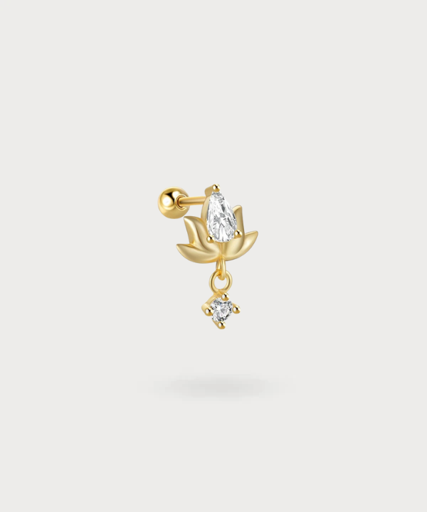 Miriam lotus-shaped piercing, illuminated by a dangling zircon.