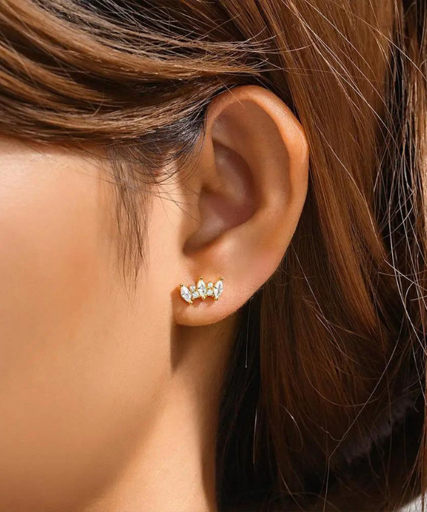 Women’s ear piercing with zircons.