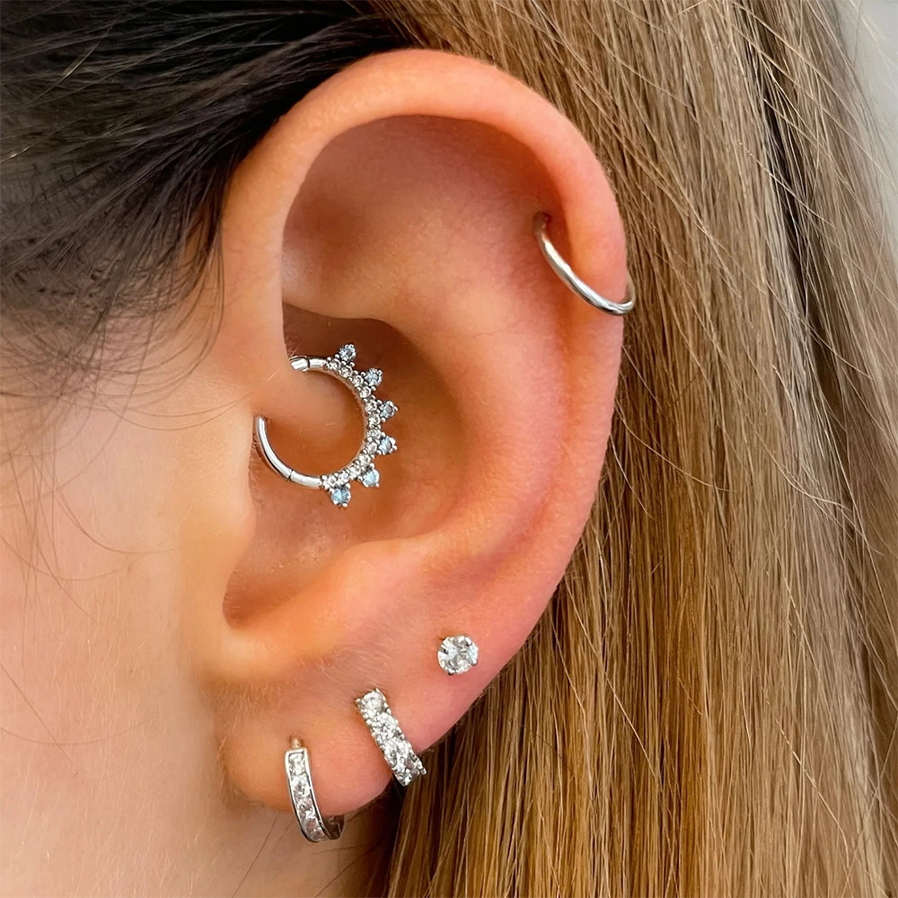 Gold hoop Earlobe piercing with embedded diamonds for women