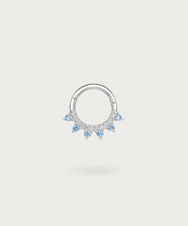 Gold hoop Earlobe piercing with embedded blue diamonds