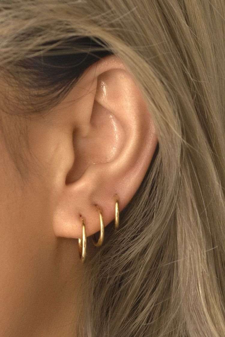 Close-up of the Paulina Forward Helix Hoop Piercing, worn