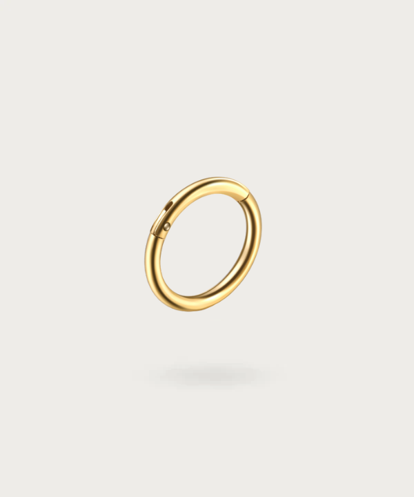 Close-up of the Paulina Forward Helix Hoop Piercing, highlighting the superior quality of the gold titanium