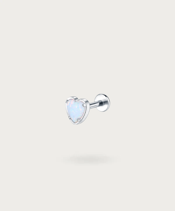 "Close-up view of the silver Titanium Opal Stone Heart Helix Piercing."