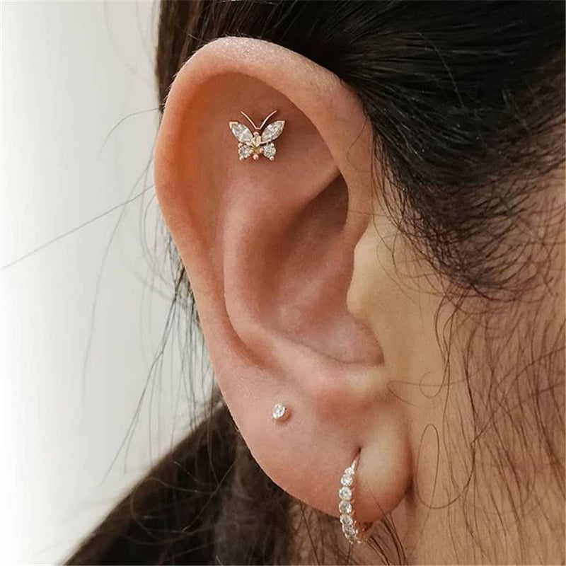 "Gold Butterfly Tragus Piercing worn, demonstrating its elegant allure."