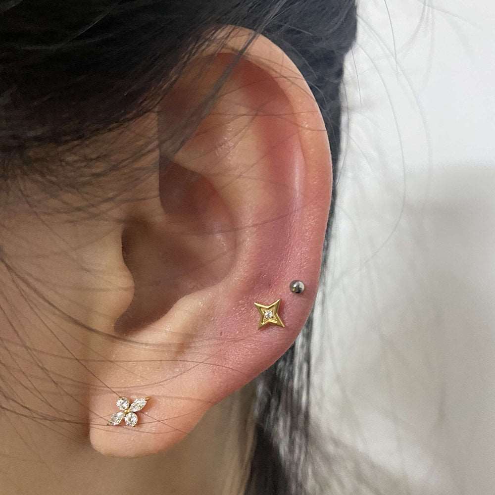 The Forward Helix Flower Piercing worn, illustrating its natural and poetic appeal. Woman