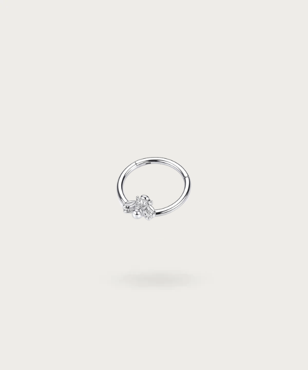Side view of silver titanium bee hoop piercing