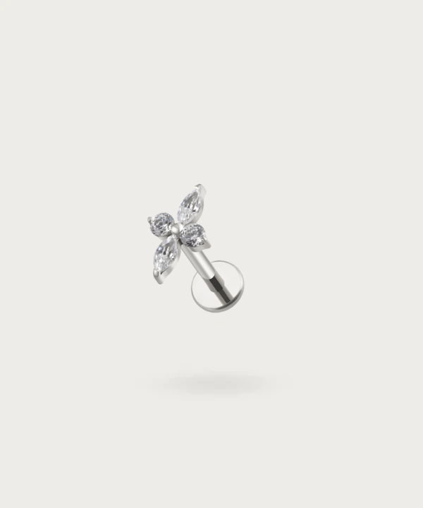 The Forward Helix Flower Piercing on a neutral background, highlighting its delicate floral design. Silver color
