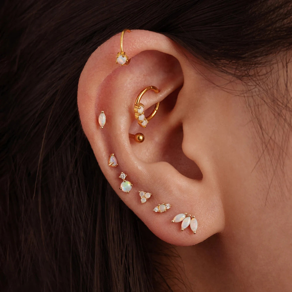 The Helix Piercing with Opal worn on an ear.