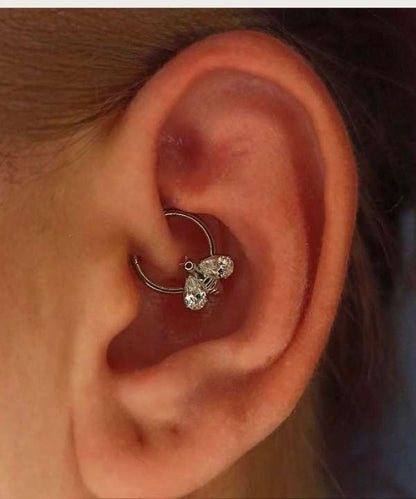 "Silver Bee Hoop Piercing worn on a female ear."