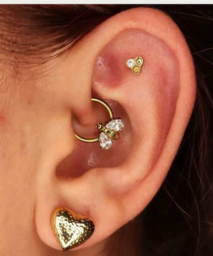 "Golden Bee Hoop Piercing worn on a female ear."