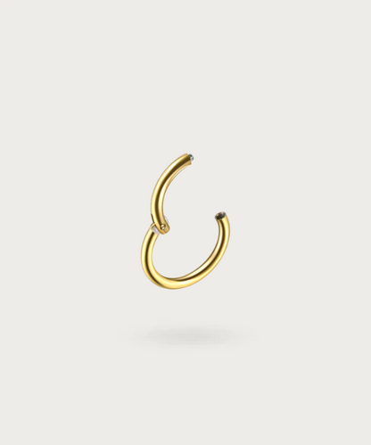 Close-up of the Paulina Conch Hoop Piercing, gold clicker