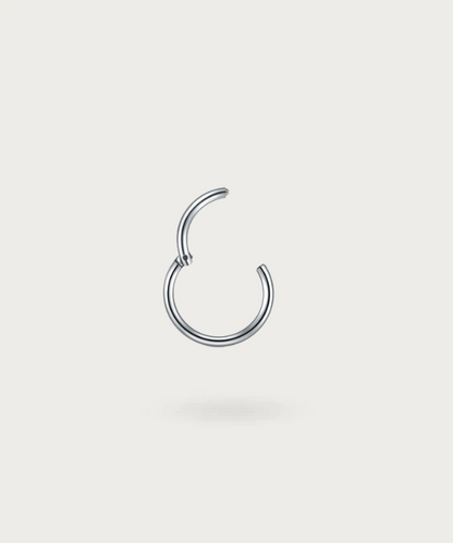 Close-up of the Paulina Conch Hoop Piercing, silver clicker