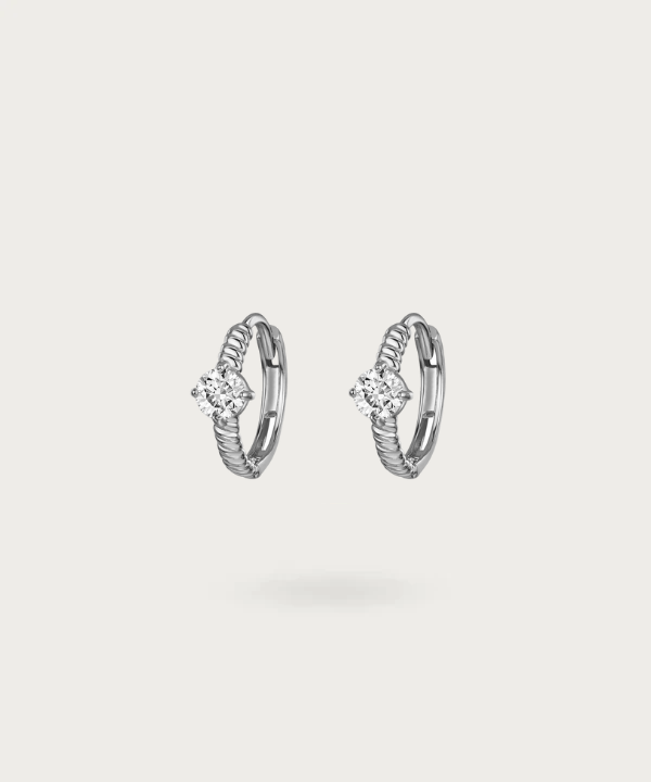 Embellish any look with Abril's intricately designed hoops and their central shimmering zirconia.