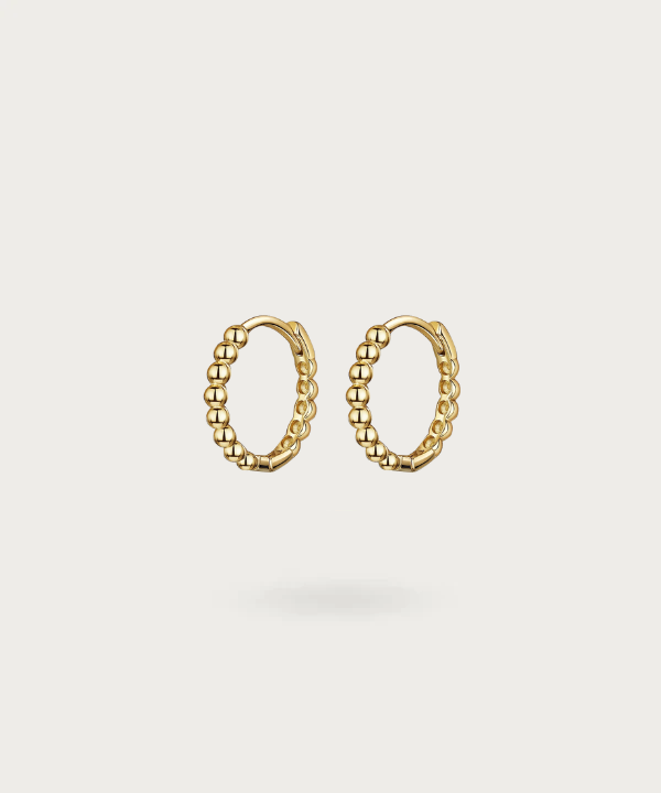 Vega's SMALL hoop earrings highlighting radiant minimalism in gold or silver.