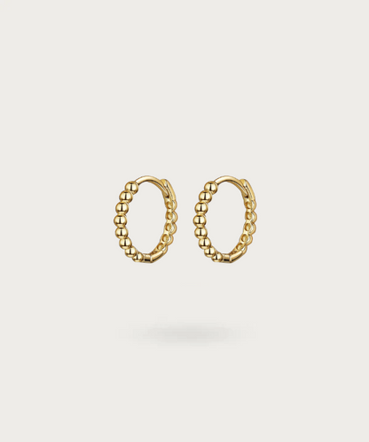 Vega's SMALL hoop earrings highlighting radiant minimalism in gold or silver.