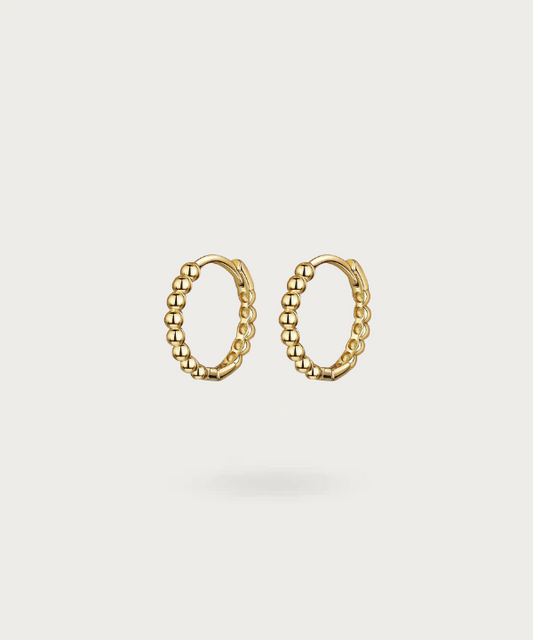 Vega's SMALL hoop earrings highlighting radiant minimalism in gold or silver.
