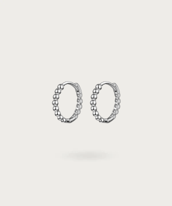 Immerse in Vega's delicate craftsmanship with sterling silver hoops, available in gold or silver finishes.