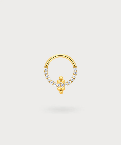 Alessandra Daith Piercing featuring sparkling zircons on golden titanium