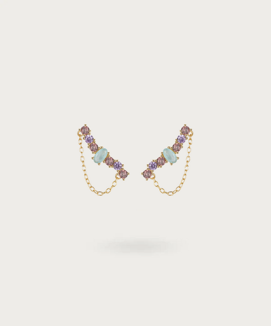 Delicate curved silver earrings studded with purple zirconia and blue stone.