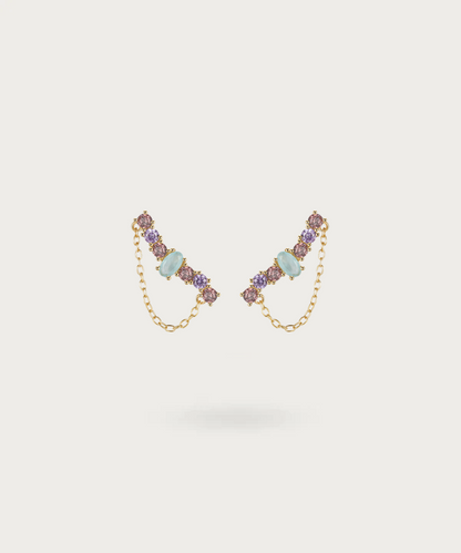 Delicate curved silver earrings studded with purple zirconia and blue stone.