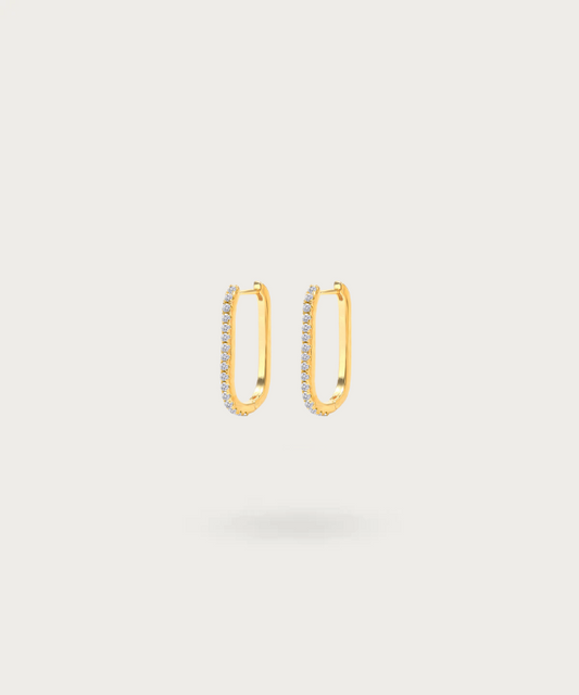 Alegria's rectangular gold-plated hoop earrings, highlighting the radiant zirconia set against a luminous sterling silver backdrop.