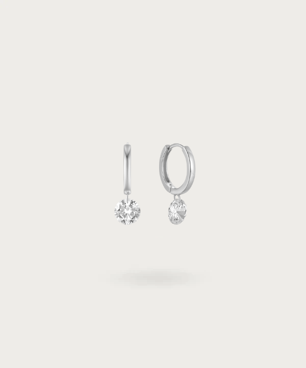 Simplistic sterling silver earrings with a shimmering zirconia centerpiece by Vicenta.