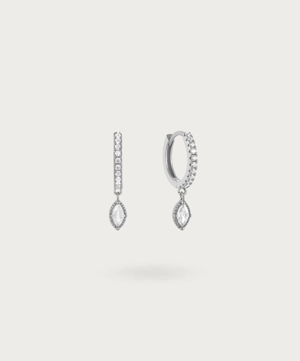 Subtle glamour on display: Silver earrings with small zirconia and a dangling centerpiece.