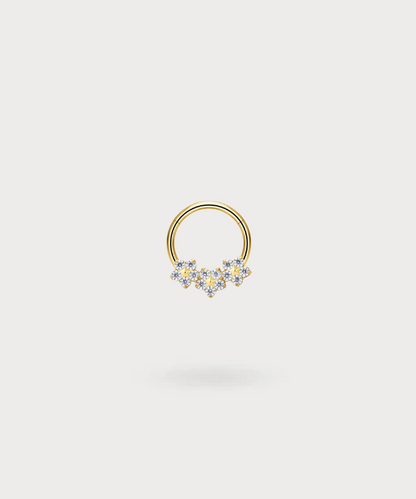 "Olaya Helix Piercing Ring in titanium with a golden finish, decorated with flowers and bright zircons."