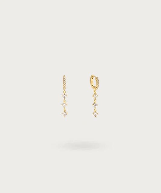 Carolina's sterling silver hoops studded with zirconias and adorned with a three-zirconia chain.