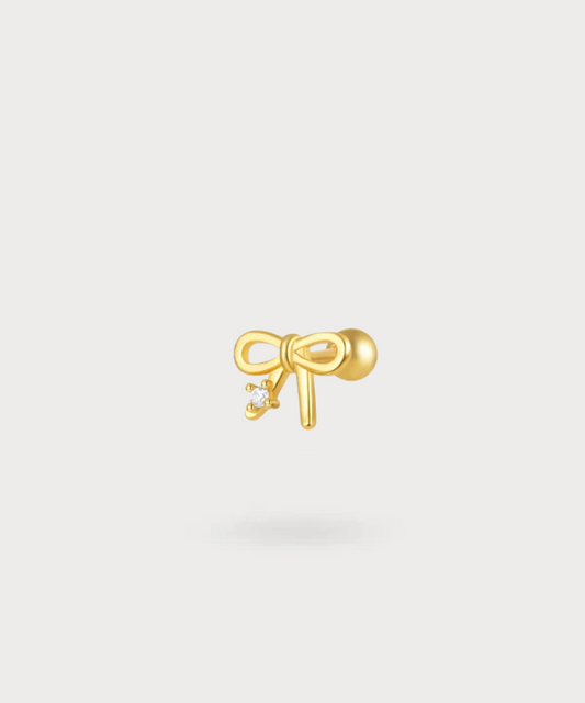 Isabel, a subtle earlobe piercing with a charming decorative knot