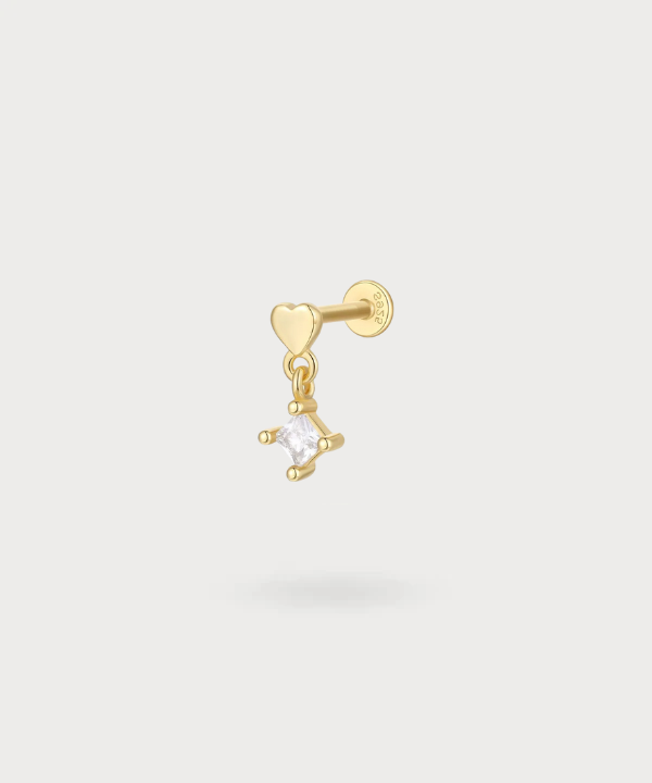 Enara lobe piercing with a golden heart and a zircon star