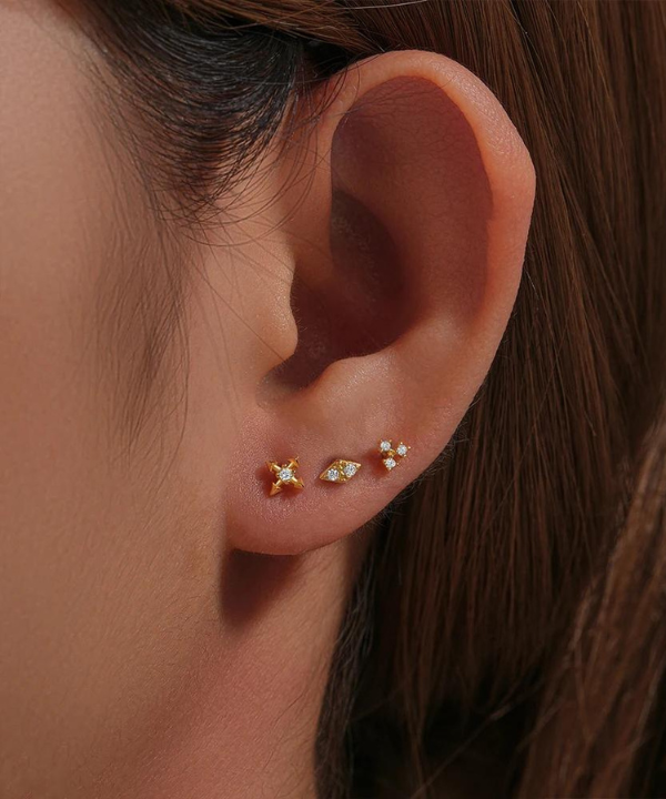 Golden Elegance of the Adrianna Forward Helix Piercing, a touch of sparkling nature.
