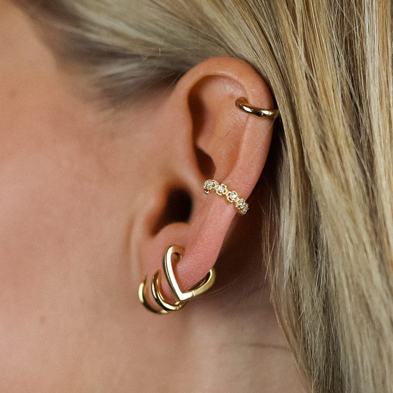 "Gold-plated 925 Sterling Silver Helix Heart Ring Piercing worn on a feminine ear."