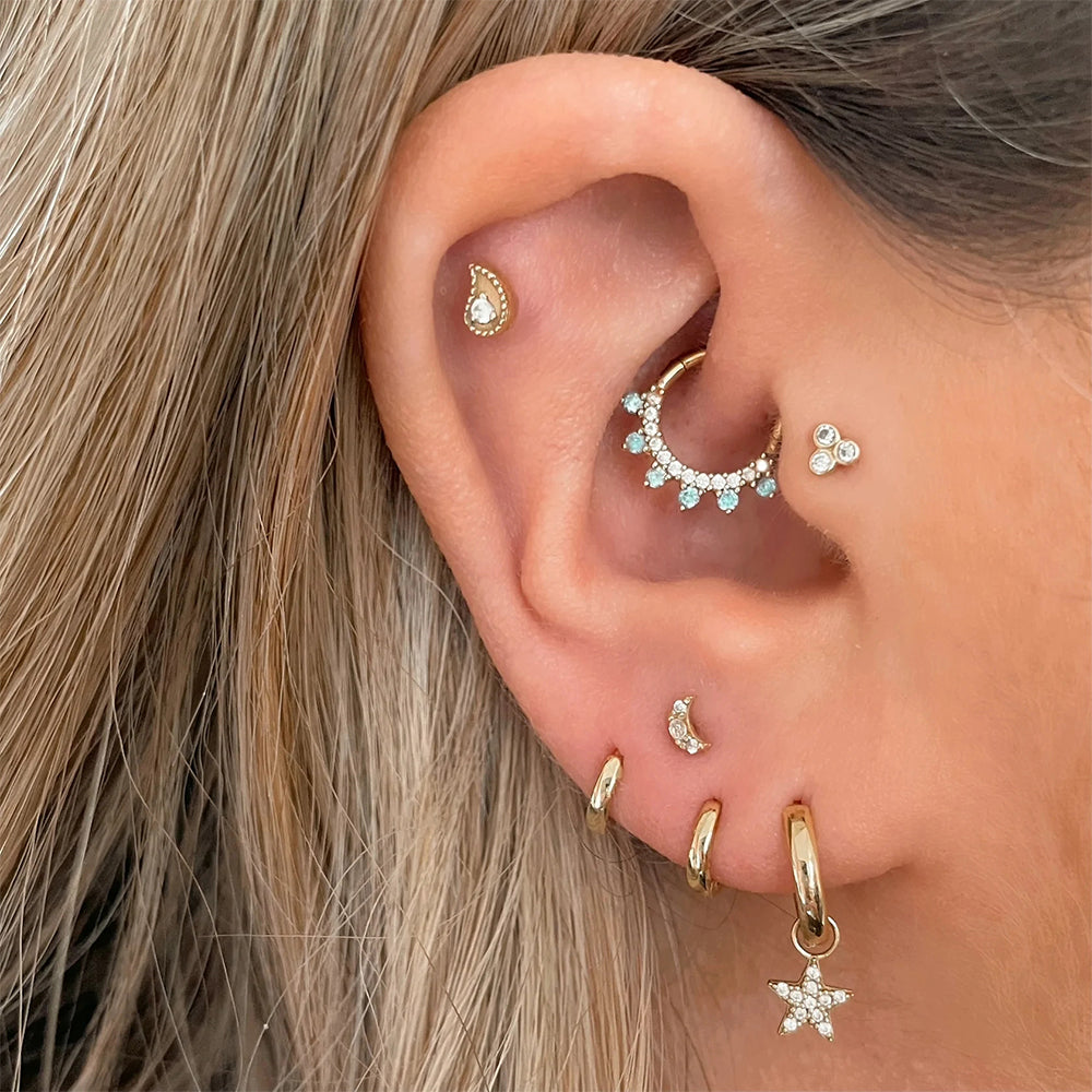 Gold hoop Daith  piercing with embedded diamonds for women
