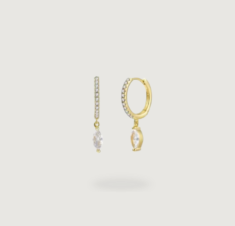 Subtle glamour on display: gold earrings with small zirconia and a dangling centerpiece.