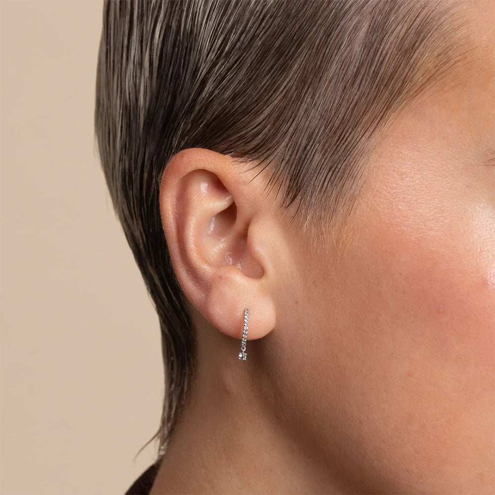 Elevate your jewelry game with Sol's hoops, combining static and dangling zirconias.