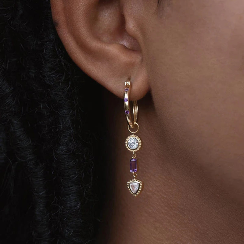 A tribute to elegance, Karla's sterling silver hoops shine with contrasting white and violet zirconia, perfect for any occasion.