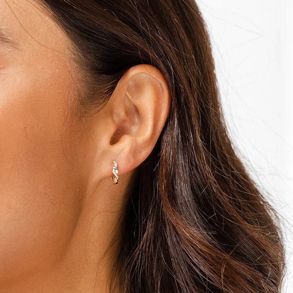 A timeless twist: Sparkling zirconia embedded in Liliana's twisted silver hoops.