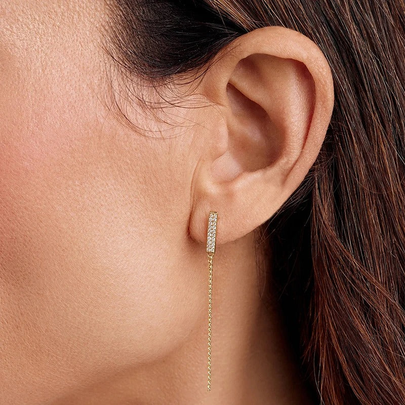 "Gina long earrings blend simplicity with elegance in a unique piece of jewelry."