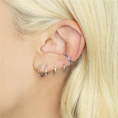 "Silver Colorful Conch Hoop worn on a female ear."