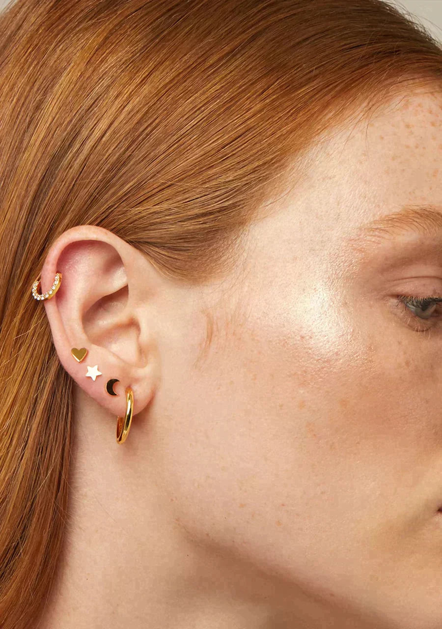 A worn view of the Tragus Star Piercing, demonstrating its celestial allure on a female model