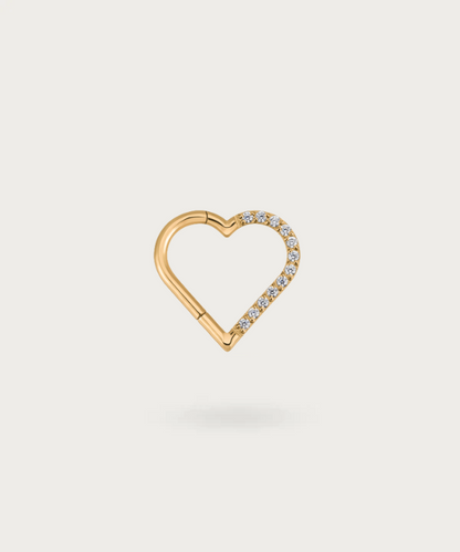 Close-up view of the left golden Titanium Heart Clicker Piercing