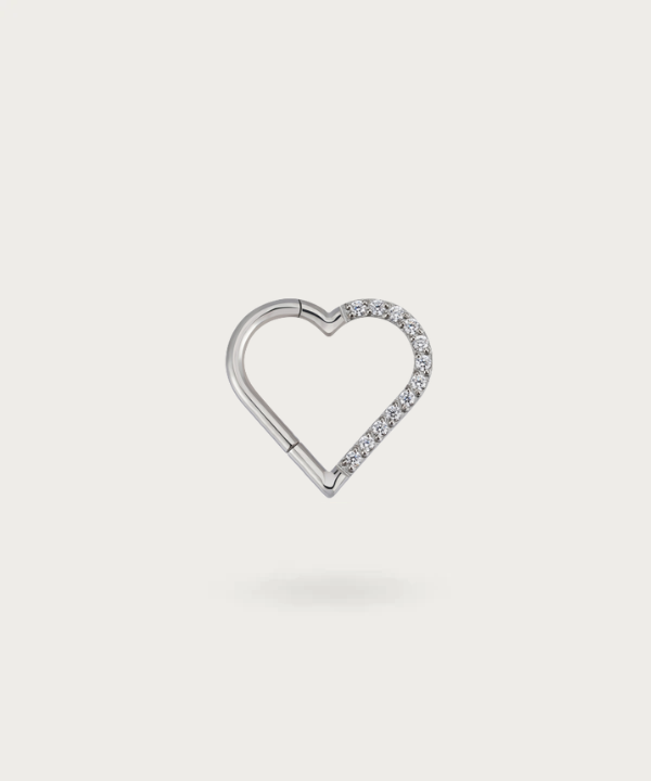 Close-up view of the left silver Titanium Heart Clicker Daith Piercing