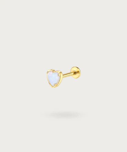 "Close-up view of the golden Titanium Opal Stone Heart Flat Piercing."