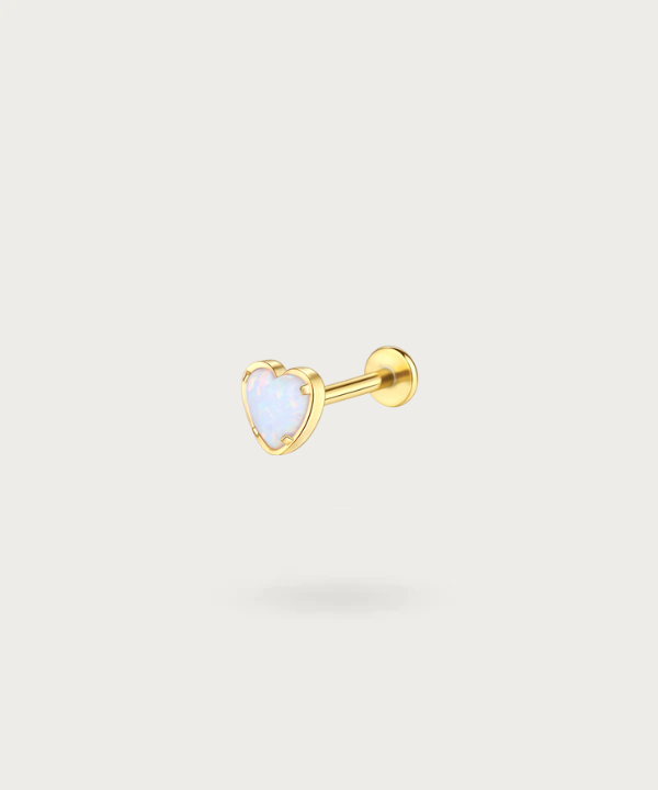 "Close-up view of the golden Titanium Opal Stone Heart Tragus Piercing."
