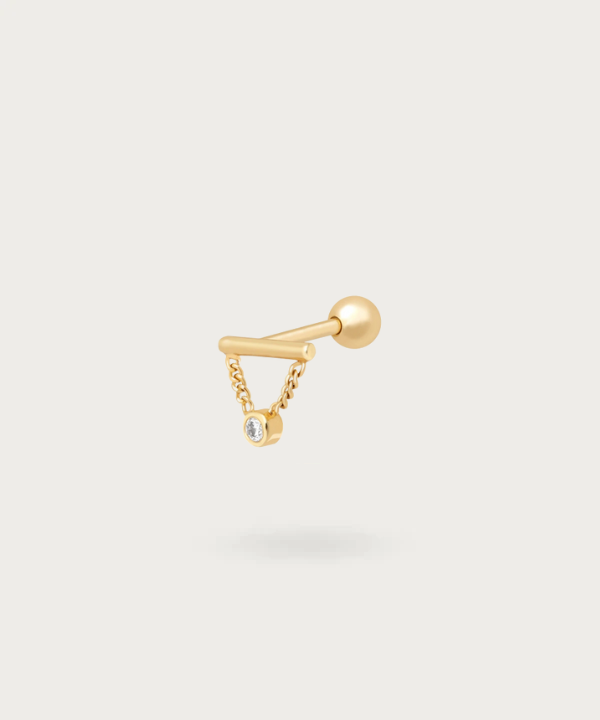 Forward Helix Pendant Piercing with a golden finish.