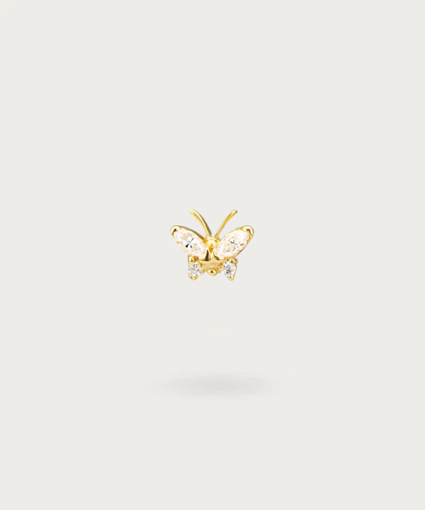 "Close-up view of the gold Butterfly Forward Helix Piercing."